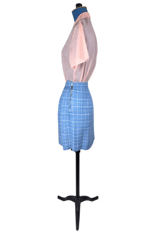 Vintage 1960s blue and white cotton plaid tweed skirt with front kick pleat. The dress closes in the side with a metal Talon zipper, and is unlined.