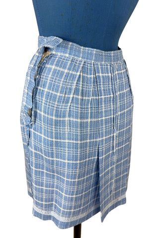 Vintage 1960s blue and white cotton plaid tweed skirt with front kick pleat. The dress closes in the side with a metal Talon zipper, and is unlined.