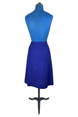 Vintage 1970s A-line skirt in navy blue cotton with pink heart shaped pockets and stripe down the front. Closes in the left side with four hook and eye closures.