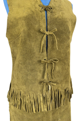 Vintage 1960s fringed suede vest and miniskirt set in olive green suede leather. The vest closes with four ties laced through holes in both sides of the vest. The skirt has open lacing on both hips, with matching suede ties.