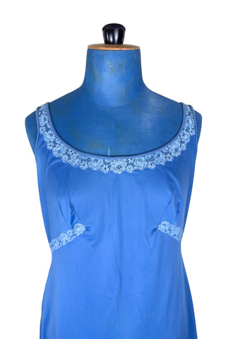 Vintage 1960s full slip in cornflower blue nylon with light blue inset lace at the collar, underbust, and hem.