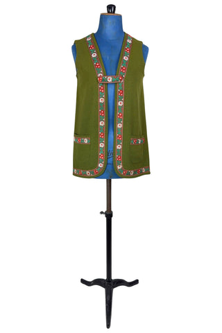 Vintage Trachten-style green wool folk vest featuring floral embroidery trim and a closing tab which fastens with a snap.