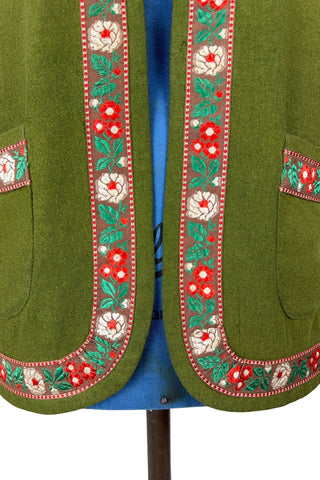 Vintage Trachten-style green wool folk vest featuring floral embroidery trim and a closing tab which fastens with a snap.
