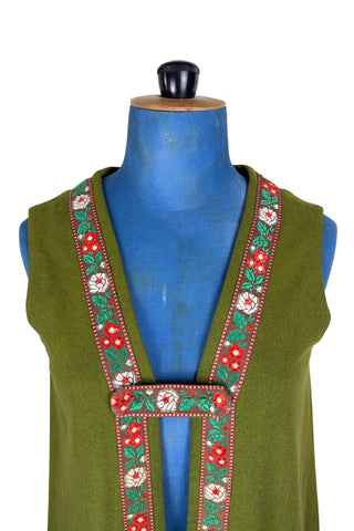 Vintage Trachten-style green wool folk vest featuring floral embroidery trim and a closing tab which fastens with a snap.