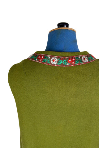 Vintage Trachten-style green wool folk vest featuring floral embroidery trim and a closing tab which fastens with a snap.