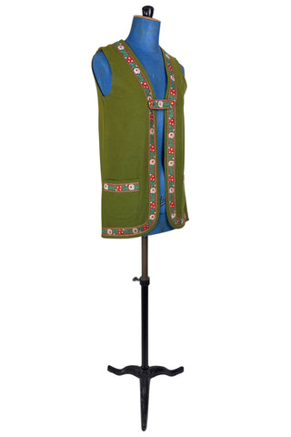 Vintage Trachten-style green wool folk vest featuring floral embroidery trim and a closing tab which fastens with a snap.
