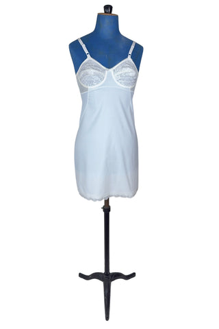 Vintage 1960s full slip with built-in bra. Designed as a close fitting foundation garment which provides a smoothing effect. The front and back panels of the skirt are made of 100% nylon, which gives more sturdy support, while the side panels and bra band have a nylon-spandex blend with more stretch to hug your curves.

Marked size 32 B.