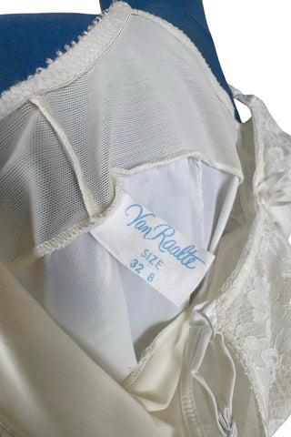 Vintage 1960s full slip with built-in bra. Designed as a close fitting foundation garment which provides a smoothing effect. The front and back panels of the skirt are made of 100% nylon, which gives more sturdy support, while the side panels and bra band have a nylon-spandex blend with more stretch to hug your curves.

Marked size 32 B.