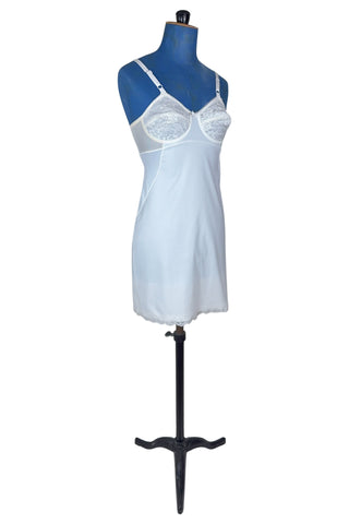 Vintage 1960s full slip with built-in bra. Designed as a close fitting foundation garment which provides a smoothing effect. The front and back panels of the skirt are made of 100% nylon, which gives more sturdy support, while the side panels and bra band have a nylon-spandex blend with more stretch to hug your curves.

Marked size 32 B.