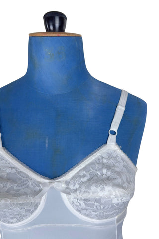 Vintage 1960s full slip with built-in bra. Designed as a close fitting foundation garment which provides a smoothing effect. The front and back panels of the skirt are made of 100% nylon, which gives more sturdy support, while the side panels and bra band have a nylon-spandex blend with more stretch to hug your curves.

Marked size 32 B.