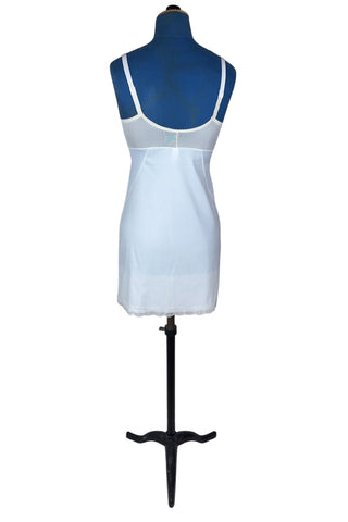 Vintage 1960s full slip with built-in bra. Designed as a close fitting foundation garment which provides a smoothing effect. The front and back panels of the skirt are made of 100% nylon, which gives more sturdy support, while the side panels and bra band have a nylon-spandex blend with more stretch to hug your curves.

Marked size 32 B.