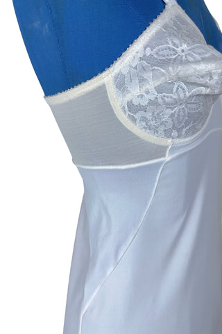 Vintage 1960s full slip with built-in bra. Designed as a close fitting foundation garment which provides a smoothing effect. The front and back panels of the skirt are made of 100% nylon, which gives more sturdy support, while the side panels and bra band have a nylon-spandex blend with more stretch to hug your curves.

Marked size 32 B.