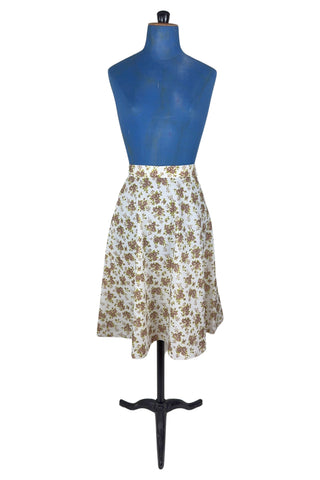 Vintage 1970s A-line skirt by White Stag with green and brown floral print. The skirt closes in the side with a Lightning zipper.