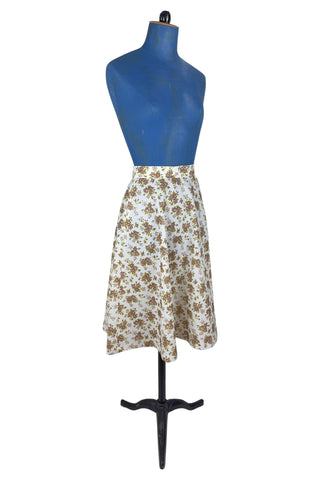 Vintage 1970s A-line skirt by White Stag with green and brown floral print. The skirt closes in the side with a Lightning zipper.