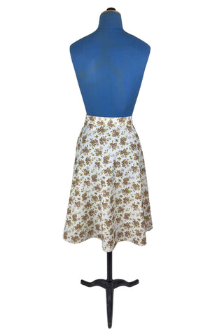 Vintage 1970s A-line skirt by White Stag with green and brown floral print. The skirt closes in the side with a Lightning zipper.
