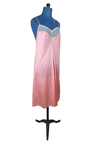 Vintage 1970s nightgown in light pink nylon jersey with wide white lace panel at the V-neckline.
By Claudel. Made in Canada.