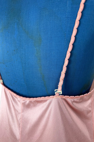 Vintage 1970s nightgown in light pink nylon jersey with wide white lace panel at the V-neckline.
By Claudel. Made in Canada.