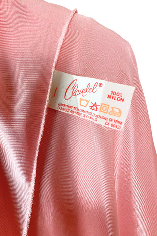 Vintage 1970s nightgown in light pink nylon jersey with wide white lace panel at the V-neckline.
By Claudel. Made in Canada.