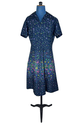 Vintage 1970s navy blue short sleeve A-line dress with tiny multicolour floral print. Closes with a zipper down the front.

Designed by Second Round. Made in Canada.