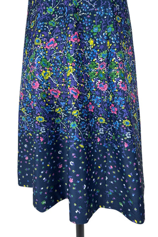 Vintage 1970s navy blue short sleeve A-line dress with tiny multicolour floral print. Closes with a zipper down the front.

Designed by Second Round. Made in Canada.