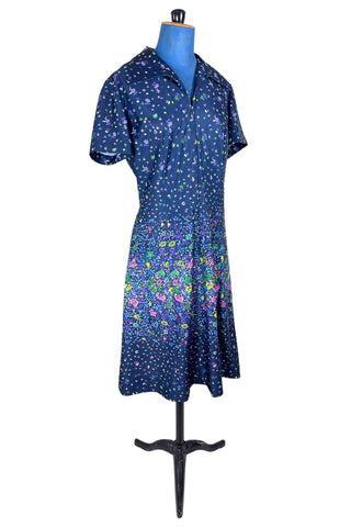 Vintage 1970s navy blue short sleeve A-line dress with tiny multicolour floral print. Closes with a zipper down the front.

Designed by Second Round. Made in Canada.