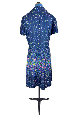 Vintage 1970s navy blue short sleeve A-line dress with tiny multicolour floral print. Closes with a zipper down the front.

Designed by Second Round. Made in Canada.