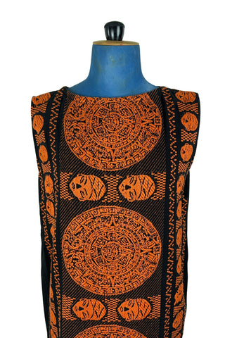 Vintage 1960s cotton shift dress with black and orange Aztec sun stone (calendar stone) woven motif. Straight, easy classic shift fit, with slight shaping from darts at the bust. The dress has no zipper or other closures, and is unlined.