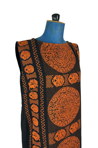 Vintage 1960s cotton shift dress with black and orange Aztec sun stone (calendar stone) woven motif. Straight, easy classic shift fit, with slight shaping from darts at the bust. The dress has no zipper or other closures, and is unlined.