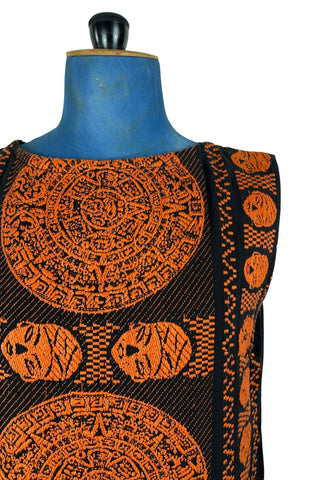 Vintage 1960s cotton shift dress with black and orange Aztec sun stone (calendar stone) woven motif. Straight, easy classic shift fit, with slight shaping from darts at the bust. The dress has no zipper or other closures, and is unlined.