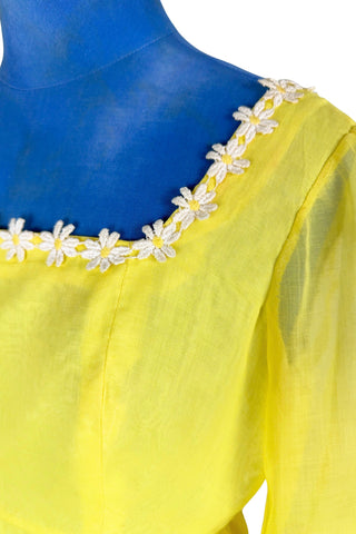 Vintage 1960s yellow empire waist dress with square neckline trimmed with daisy chain lace. Made from fine, semi-sheer cotton muslin, the long sleeves are unlined, while the bodice and skirt have a matching yellow acetate lining. The dress closes in the back with a cotton twill zipper.

Designed by David E. Rea Dresses Limited. Made in Canada.