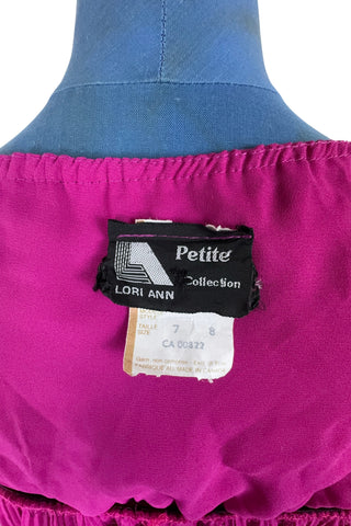 Vintage 1970s cocktail dress in raspberry chiffon with an accordion pleated skirt with elasticized waist.

Designed by Lori Ann Petites. Made in Canada.

Marked size 7/8. Fits like a medium to large.
