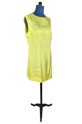 Vintage 1960s shift dress in sunny yellow rayon that resembles shot silk.  Sleeveless, with a round neckline. The dress closes in the back with a cotton twill zipper, and is unlined.