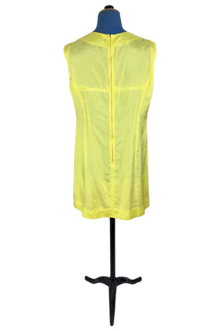 Vintage 1960s shift dress in sunny yellow rayon that resembles shot silk.  Sleeveless, with a round neckline. The dress closes in the back with a cotton twill zipper, and is unlined.