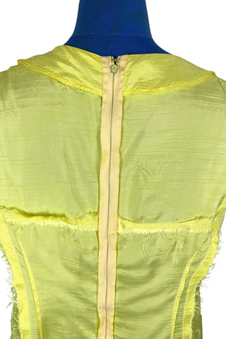 Vintage 1960s shift dress in sunny yellow rayon that resembles shot silk.  Sleeveless, with a round neckline. The dress closes in the back with a cotton twill zipper, and is unlined.