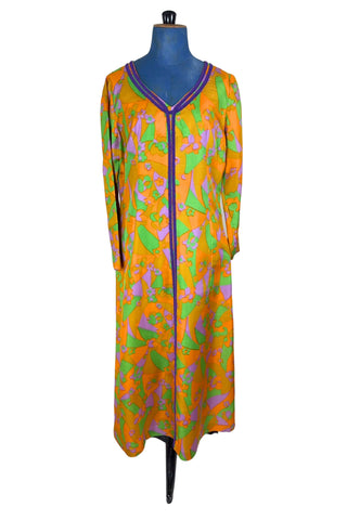 Vintage 1960s psychedelic print maxi dress in bright orange, green and purple abstract floral print, with purple soutache trim detail around the collar and down the front. The dress has long sleeves, and closes in the back with a metal zipper. 

Designed with an A-line silhouette which flares gently through the hips.