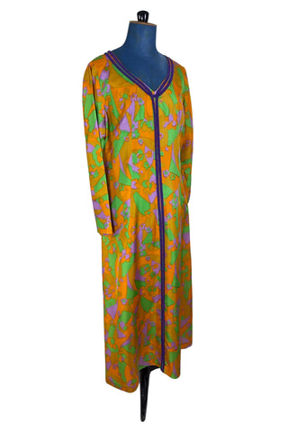Vintage 1960s psychedelic print maxi dress in bright orange, green and purple abstract floral print, with purple soutache trim detail around the collar and down the front. The dress has long sleeves, and closes in the back with a metal zipper. 

Designed with an A-line silhouette which flares gently through the hips.