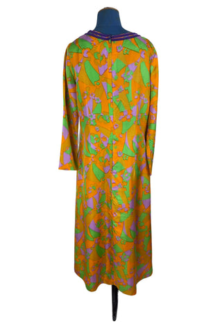 Vintage 1960s psychedelic print maxi dress in bright orange, green and purple abstract floral print, with purple soutache trim detail around the collar and down the front. The dress has long sleeves, and closes in the back with a metal zipper. 

Designed with an A-line silhouette which flares gently through the hips.