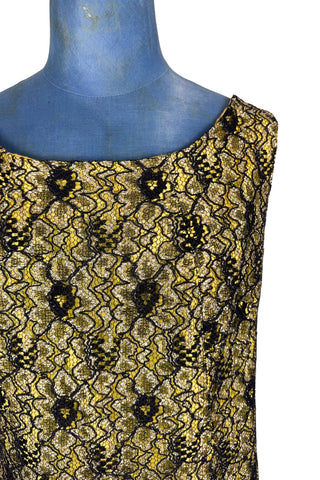 Vintage 1960s cocktail dress with sheer black lace layered over a bright yellow lining. The dress is sleeveless, with straps that narrow towards the back, and a wide, round neckline. Closes in the back with a cotton twill zipper.