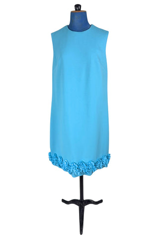 Vintage 1960s dress in cornflower blue textured crepe with a wide zigzag ruffle trim along the hem. The dress is sleeveless, with a round neckline.

The dress closes in the back with a metal zipper, and is unlined.

Designed by Nancy G. “That Young Sophisticated Look”.