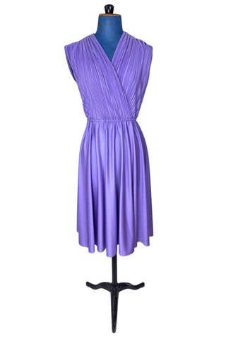 Vintage 1970s sleeveless dress in lilac purple with wrap style V neck bodice with accordion pleating. The waist is elasticized.