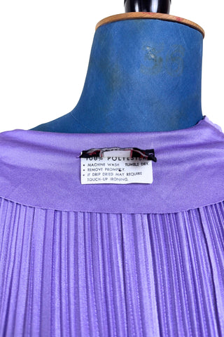 Vintage 1970s sleeveless dress in lilac purple with wrap style V neck bodice with accordion pleating. The waist is elasticized.