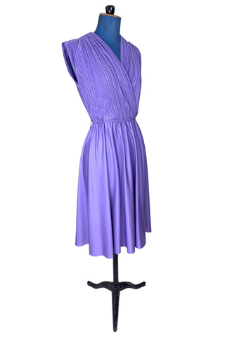 Vintage 1970s sleeveless dress in lilac purple with wrap style V neck bodice with accordion pleating. The waist is elasticized.