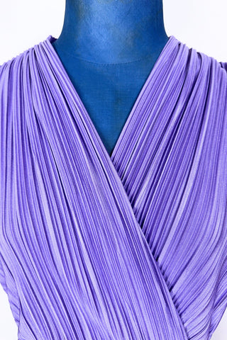 Vintage 1970s sleeveless dress in lilac purple with wrap style V neck bodice with accordion pleating. The waist is elasticized.