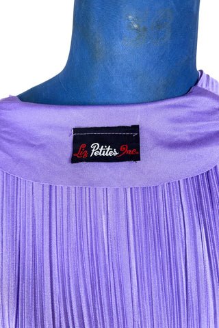Vintage 1970s sleeveless dress in lilac purple with wrap style V neck bodice with accordion pleating. The waist is elasticized.