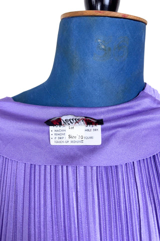 Vintage 1970s sleeveless dress in lilac purple with wrap style V neck bodice with accordion pleating. The waist is elasticized.