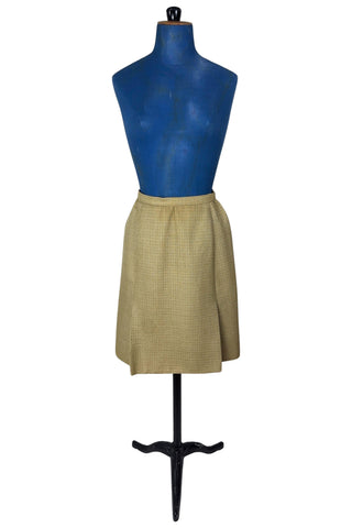 Vintage 1960s skirt suit with oversized jacket and matching skirt. The jacket features three-quarter length sleeves, bow accents at the waist, and closes with two large textured lucite buttons. The skirt has a pleat panel in the front, and closes in the back with a metal zipper.

The jacket and skirt are both lined in caramel brown rayon.

The jacket has a few light stains on the front, which would likely be removed with dry cleaning.