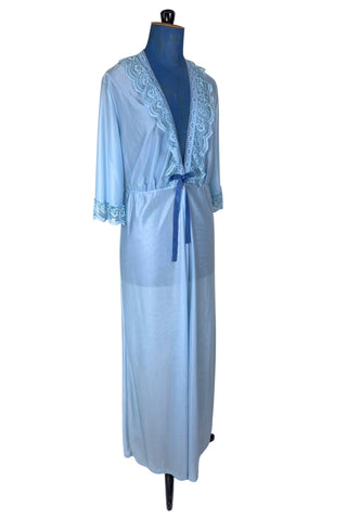 Vintage 1970s negligee robe in sky blue with wide lace trim along the deep V neckline and three-quarter length sleeve cuffs. Finished with a decorative royal blue bow. Closes at the waist with a single button.