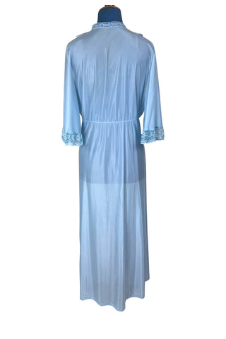 Vintage 1970s negligee robe in sky blue with wide lace trim along the deep V neckline and three-quarter length sleeve cuffs. Finished with a decorative royal blue bow. Closes at the waist with a single button.