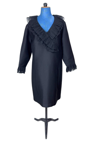 Vintage 1960s Lillie Rubin black cocktail dress with sheer, accordion pleated chiffon ruffle collar. The long sleeves have matching double-layered chiffon pleated cuffs. This amazing little black dress is perfect for any cocktail party or night on the town.

Closes in the back with a metal zipper.

Designed by Lillie Rubin.
