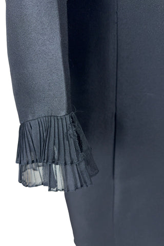 Vintage 1960s Lillie Rubin black cocktail dress with sheer, accordion pleated chiffon ruffle collar. The long sleeves have matching double-layered chiffon pleated cuffs. This amazing little black dress is perfect for any cocktail party or night on the town.

Closes in the back with a metal zipper.

Designed by Lillie Rubin.